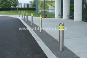 Stainless steel bollard covers with reflective strips outside a hospital