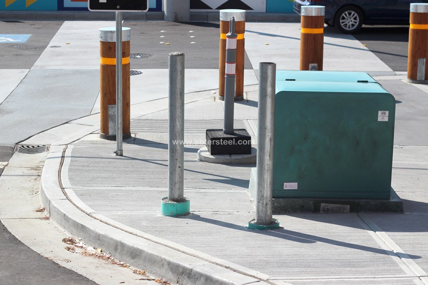 steel pipe posts protect a pad-mounted transformer